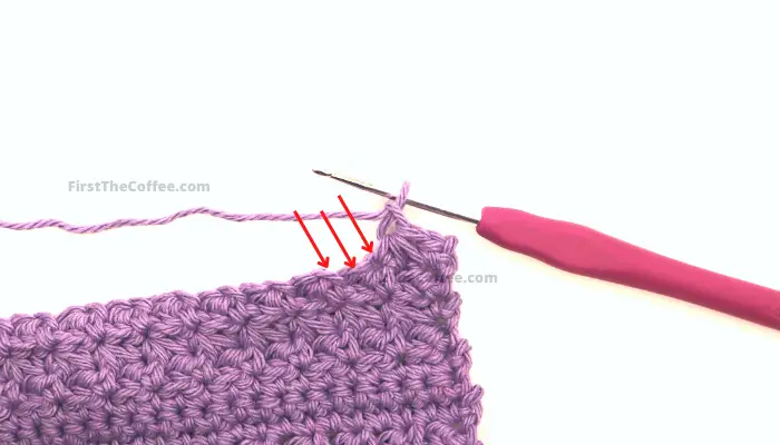 Arrows point to the 3 stitches you will use for the next trinity stitch.