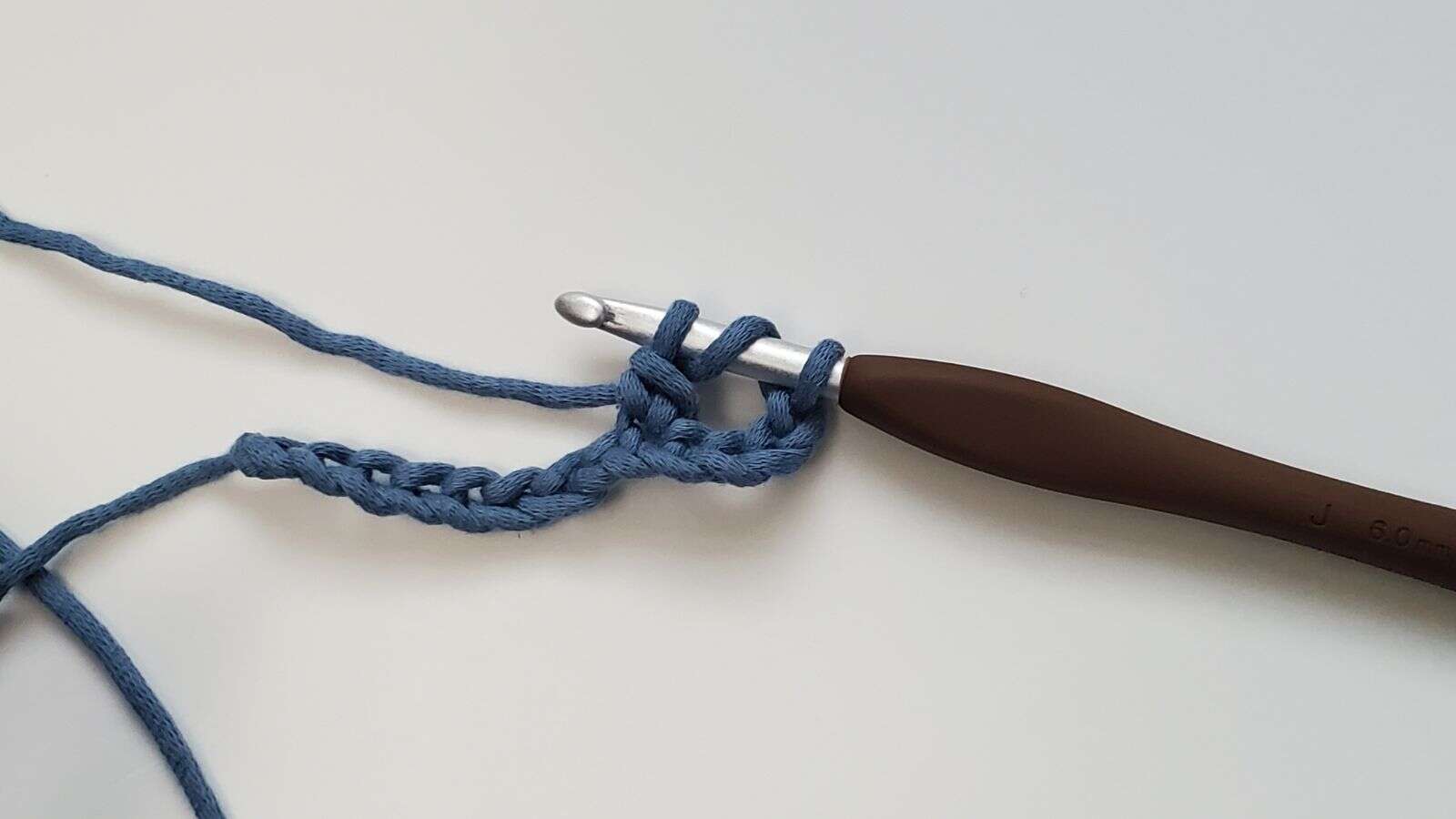 3 loops on crochet hook after pulling a loop through the first 2 loop while making a triple crochet
