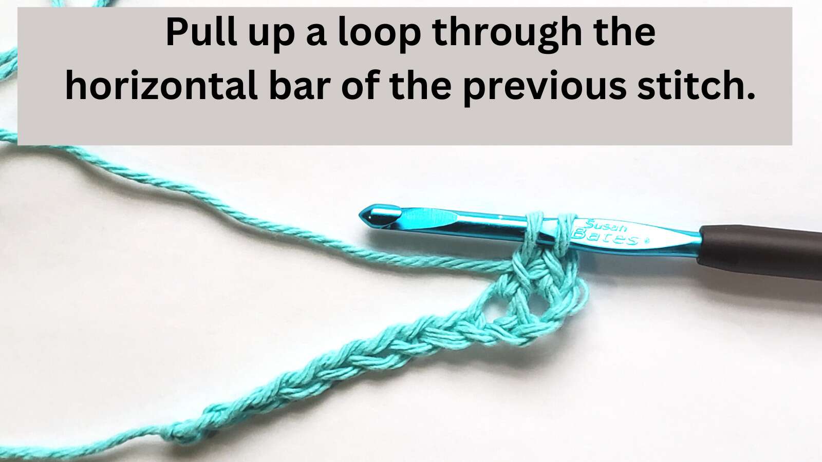 Loop pulled up through the horizontal bar of the previous stitch