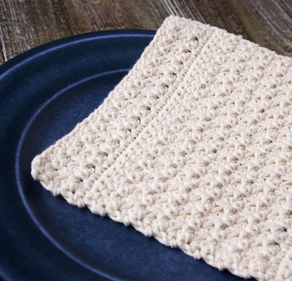 Crochet dishcloth on a blue plate