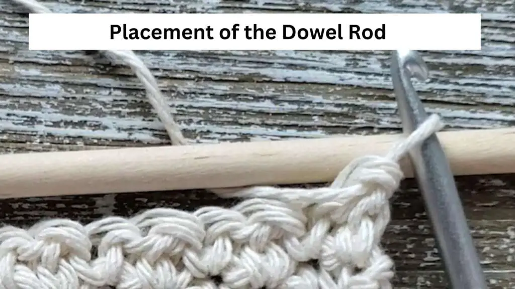 Placing the dowel rod on top of the last row of stitches